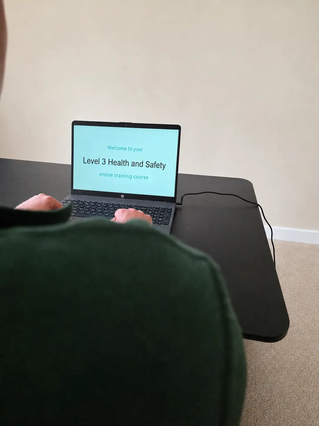 A ProLand operative completing an online health and safety course on a laptop