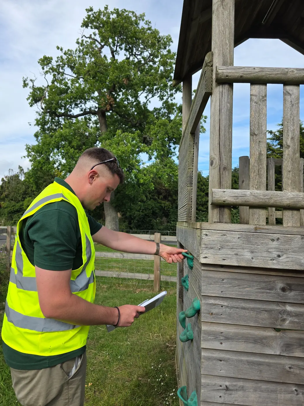 ProLand inspector checking the condition of timber playground equipment